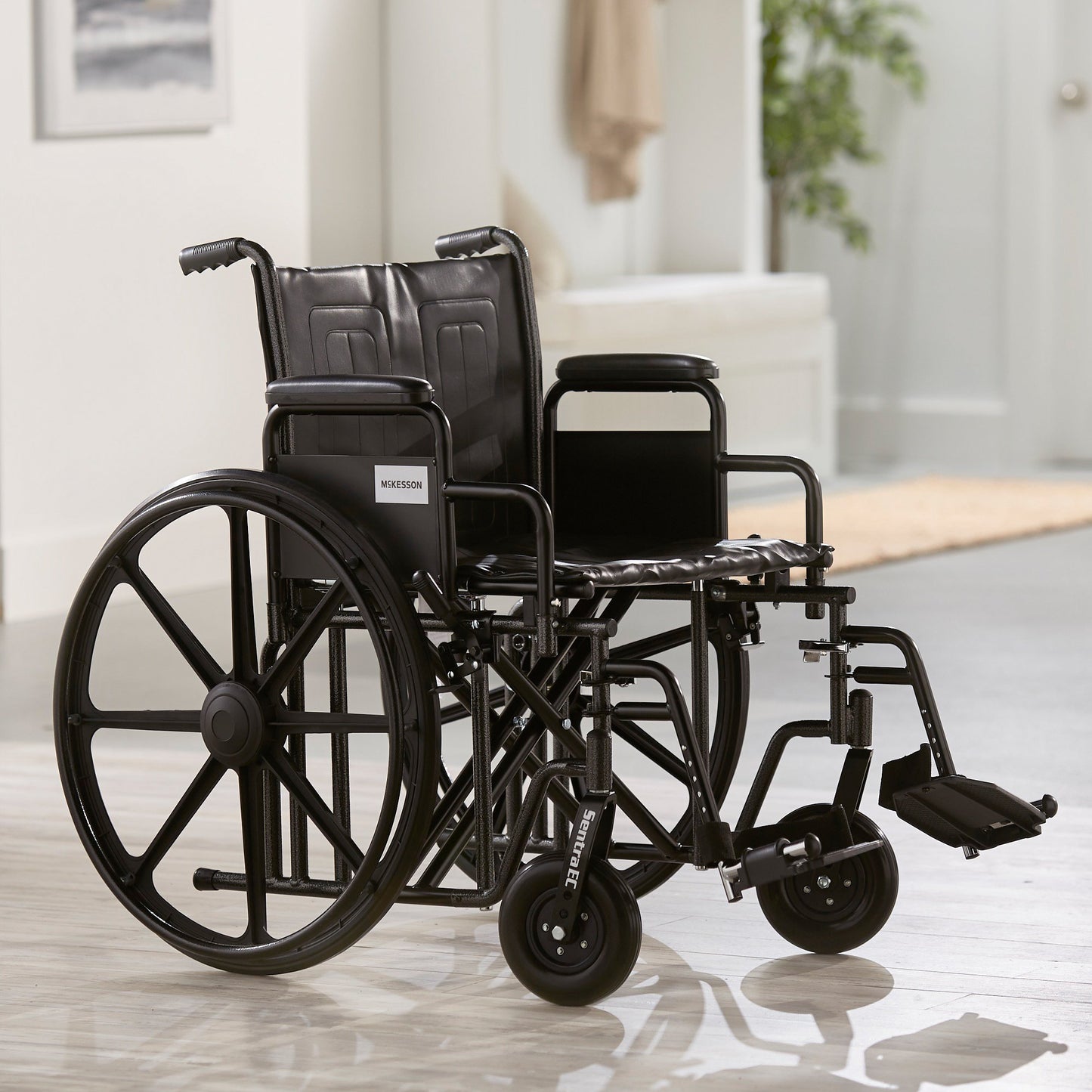McKesson Bariatric Wheelchair Dual Axle Desk Length Arm Swing-Away Footrest Black Upholstery 22 Inch Seat Width Adult 450 lbs. Weight Capacity (1065280_EA)