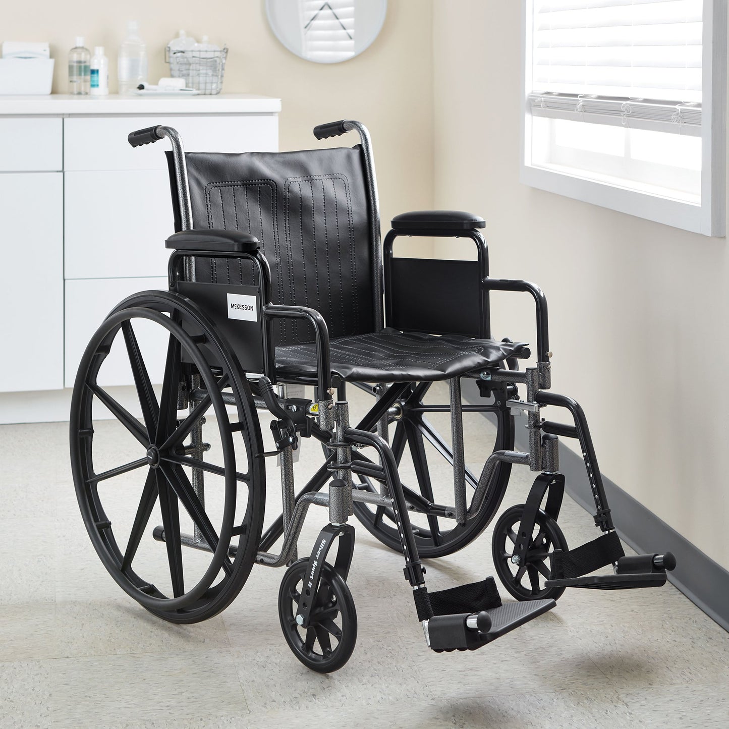 McKesson Lightweight Wheelchair Dual Axle Desk Length Arm Swing-Away Elevating Legrest Black Upholstery 18 Inch Seat Width Adult 300 lbs. Weight Capacity (1065285_EA)